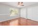 Inviting bedroom featuring hardwood floors and a bright window with a view at 21 E Irvine Rd, Phoenix, AZ 85086