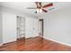 Bedroom featuring hardwood floors, a closet with sliding doors, and a ceiling fan at 21 E Irvine Rd, Phoenix, AZ 85086