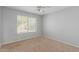Cozy bedroom featuring carpeted floors, a ceiling fan, and natural light from a window at 21 E Irvine Rd, Phoenix, AZ 85086
