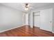 Comfortable bedroom with hardwood floors, ceiling fan, and closet space at 21 E Irvine Rd, Phoenix, AZ 85086