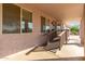 Spacious covered patio with windows and wooden railing, offering a relaxing outdoor space at 21 E Irvine Rd, Phoenix, AZ 85086