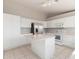 Spacious kitchen with white cabinets, island, and stainless steel refrigerator at 21 E Irvine Rd, Phoenix, AZ 85086
