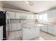 Bright kitchen featuring white cabinets, a center island, and stainless steel appliances at 21 E Irvine Rd, Phoenix, AZ 85086