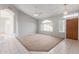 Open living room featuring neutral walls, arched windows, and carpet flooring at 21 E Irvine Rd, Phoenix, AZ 85086