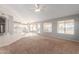 Bright and airy living room with tile flooring, carpet, and an open concept to the kitchen at 21 E Irvine Rd, Phoenix, AZ 85086
