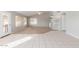 Open living room boasts neutral colors, carpet, tiled flooring, and plenty of light at 21 E Irvine Rd, Phoenix, AZ 85086
