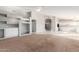 Spacious living room leads to a large kitchen with center island, neutral tones, and tile floors at 21 E Irvine Rd, Phoenix, AZ 85086