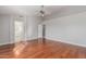 Sun-filled main bedroom with hardwood floors leading to ensuite bathroom at 21 E Irvine Rd, Phoenix, AZ 85086