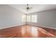 Large main bedroom with hardwood floors, ceiling fan, and bright windows at 21 E Irvine Rd, Phoenix, AZ 85086