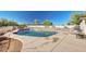 Backyard pool with surrounding deck, fenced perimeter, and desert landscape at 21 E Irvine Rd, Phoenix, AZ 85086