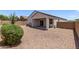 View of the home's back exterior and patio, set in a private yard with neutral ground cover at 28512 N Geode Dr, San Tan Valley, AZ 85143