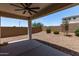 Spacious backyard featuring a covered patio, neutral ground cover, and block wall privacy fence at 28512 N Geode Dr, San Tan Valley, AZ 85143