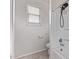 Bathroom showing a shower-tub combo with updated fixtures, tile flooring, and a window, offering a clean and bright space at 28512 N Geode Dr, San Tan Valley, AZ 85143