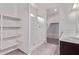 Bathroom showcasing a shower, tile floor, vanity, and built-in shelving, combining functionality and style at 28512 N Geode Dr, San Tan Valley, AZ 85143