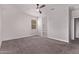 A bedroom featuring neutral walls, carpeted flooring, a ceiling fan, and a walk-in closet offers comfort and functionality at 28512 N Geode Dr, San Tan Valley, AZ 85143