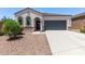 Charming single story house with arched windows, a two car garage, and pristine desert landscaping at 28512 N Geode Dr, San Tan Valley, AZ 85143