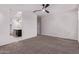 Spacious main bedroom with ceiling fan, neutral walls, carpeted floors, and connecting bathroom, ideal for comfort and privacy at 28512 N Geode Dr, San Tan Valley, AZ 85143