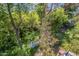 Backyard view with mature trees and foliage, plus clothes hanging on a line, and yard accessories at 3303 E Clarendon Ave, Phoenix, AZ 85018