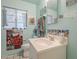 Quaint bathroom with robin's egg blue walls, a classic sink, and a decorative tile backsplash at 3303 E Clarendon Ave, Phoenix, AZ 85018