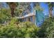 Exterior view of the home surrounded by mature trees and landscaping at 3303 E Clarendon Ave, Phoenix, AZ 85018