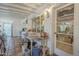 Cozy sunroom with terracotta floors and exposed-beam ceiling offers ample natural light at 3303 E Clarendon Ave, Phoenix, AZ 85018