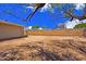 Expansive dirt backyard with block wall offering privacy and blank canvas to create the outdoor oasis at 3450 W Kaler Dr, Phoenix, AZ 85051