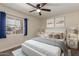 Bright bedroom with stylish decor, a comfortable bed, ceiling fan, and plenty of natural light at 3450 W Kaler Dr, Phoenix, AZ 85051