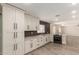 Modern kitchen featuring sleek white cabinets, quartz countertops, and stainless steel appliances at 3450 W Kaler Dr, Phoenix, AZ 85051