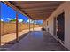 Covered patio with concrete flooring and block wall offering shade and space for outdoor activities at 3450 W Kaler Dr, Phoenix, AZ 85051