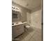 Bathroom featuring tile flooring, vanity with mirror, toilet, and tiled tub at 3827 E Sweetwater Ave, Phoenix, AZ 85032