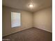 Cozy bedroom with neutral walls, carpet, and a window for natural light at 3827 E Sweetwater Ave, Phoenix, AZ 85032
