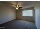 Bedroom with neutral paint, carpet, ceiling fan, and window at 3827 E Sweetwater Ave, Phoenix, AZ 85032