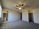 Bedroom with neutral paint, carpet, ceiling fan, closet, and bathroom at 3827 E Sweetwater Ave, Phoenix, AZ 85032