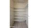 Walk-in pantry featuring tile flooring and multiple shelves at 3827 E Sweetwater Ave, Phoenix, AZ 85032