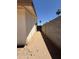 Narrow side yard featuring block wall and gate access at 3827 E Sweetwater Ave, Phoenix, AZ 85032
