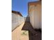 Side yard featuring dirt, partial grass, and block fencing at 3827 E Sweetwater Ave, Phoenix, AZ 85032