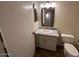 Bathroom featuring a marble countertop, white cabinets, and a toilet at 4632 E Melinda Ln, Phoenix, AZ 85050