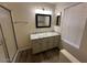 Bathroom with granite countertops, single sink vanity, and glass-enclosed shower at 4632 E Melinda Ln, Phoenix, AZ 85050