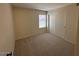 This carpeted bedroom features a window and a built in closet at 4632 E Melinda Ln, Phoenix, AZ 85050
