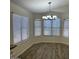 Dining area with wood floors, large windows, and modern chandelier at 4632 E Melinda Ln, Phoenix, AZ 85050