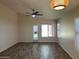 Spacious living room with high ceilings, ceiling fan, and sliding door to the backyard at 4632 E Melinda Ln, Phoenix, AZ 85050