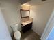 Bathroom featuring a dark vanity, mosaic tile backsplash, and modern toilet at 4849 W Northern Ave, Glendale, AZ 85301