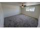 Spacious bedroom with a ceiling fan and carpet flooring and window with natural light at 4849 W Northern Ave, Glendale, AZ 85301