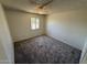 Carpeted bedroom filled with natural light, enhanced by a ceiling fan and a closet, offers cozy comfort at 4849 W Northern Ave, Glendale, AZ 85301