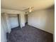 Carpeted bedroom with bi-fold closet and overhead fan offers a comfortable and organized space at 4849 W Northern Ave, Glendale, AZ 85301
