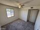 This bedroom has carpet, a window, a ceiling fan and a closet at 4849 W Northern Ave, Glendale, AZ 85301
