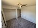This bedroom has carpet and a ceiling fan with a closet at 4849 W Northern Ave, Glendale, AZ 85301