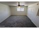 Large bedroom featuring a ceiling fan, plush carpet, and ample closet space at 4849 W Northern Ave, Glendale, AZ 85301