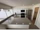Beautiful kitchen with new stainless steel appliances and breakfast bar featuring grey countertops at 4849 W Northern Ave, Glendale, AZ 85301