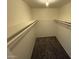 Spacious walk-in closet with neutral carpet and ample shelving for organization and storage at 4849 W Northern Ave, Glendale, AZ 85301